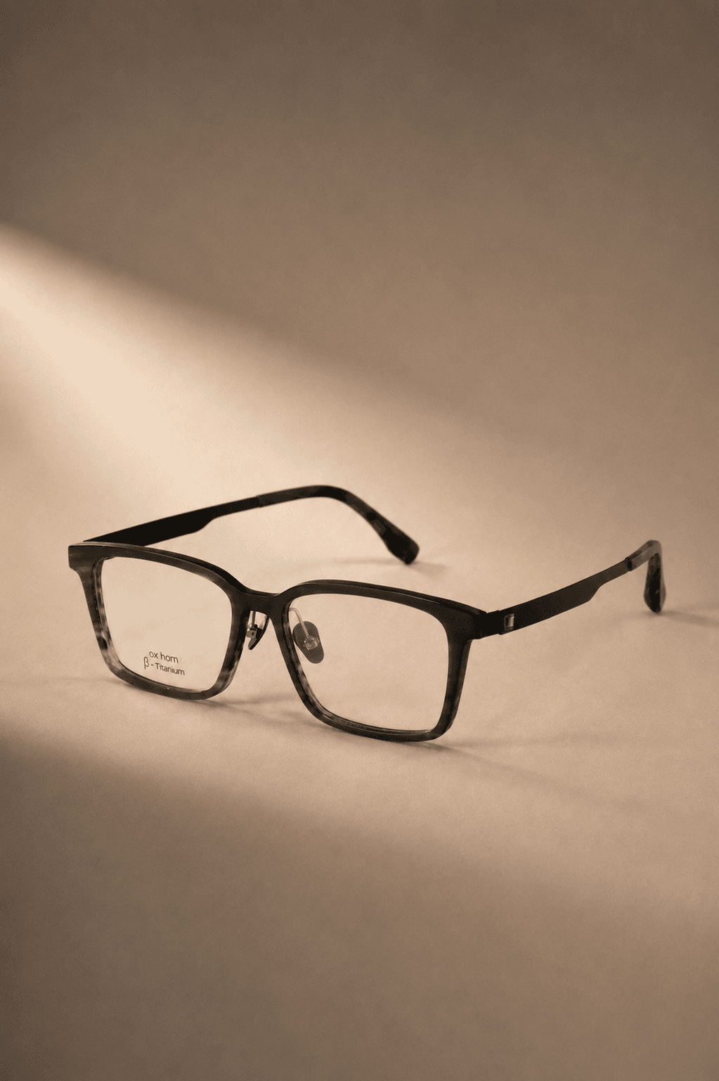 Strata optical frame on a warm neutral background
