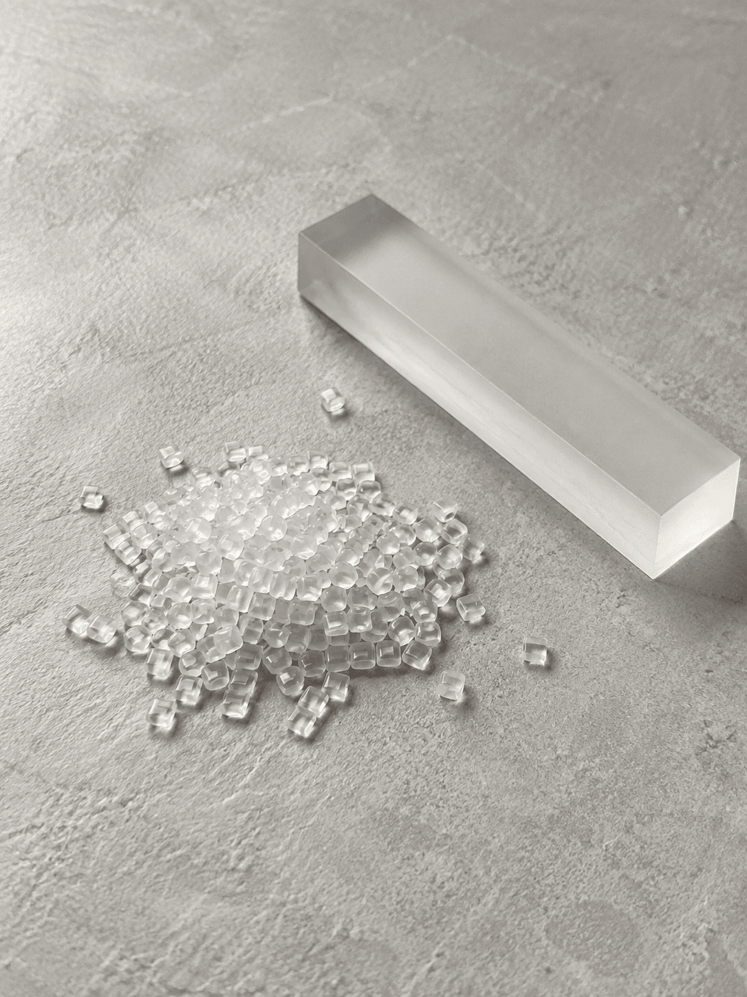 TR90 resin pellets beside a translucent material sample