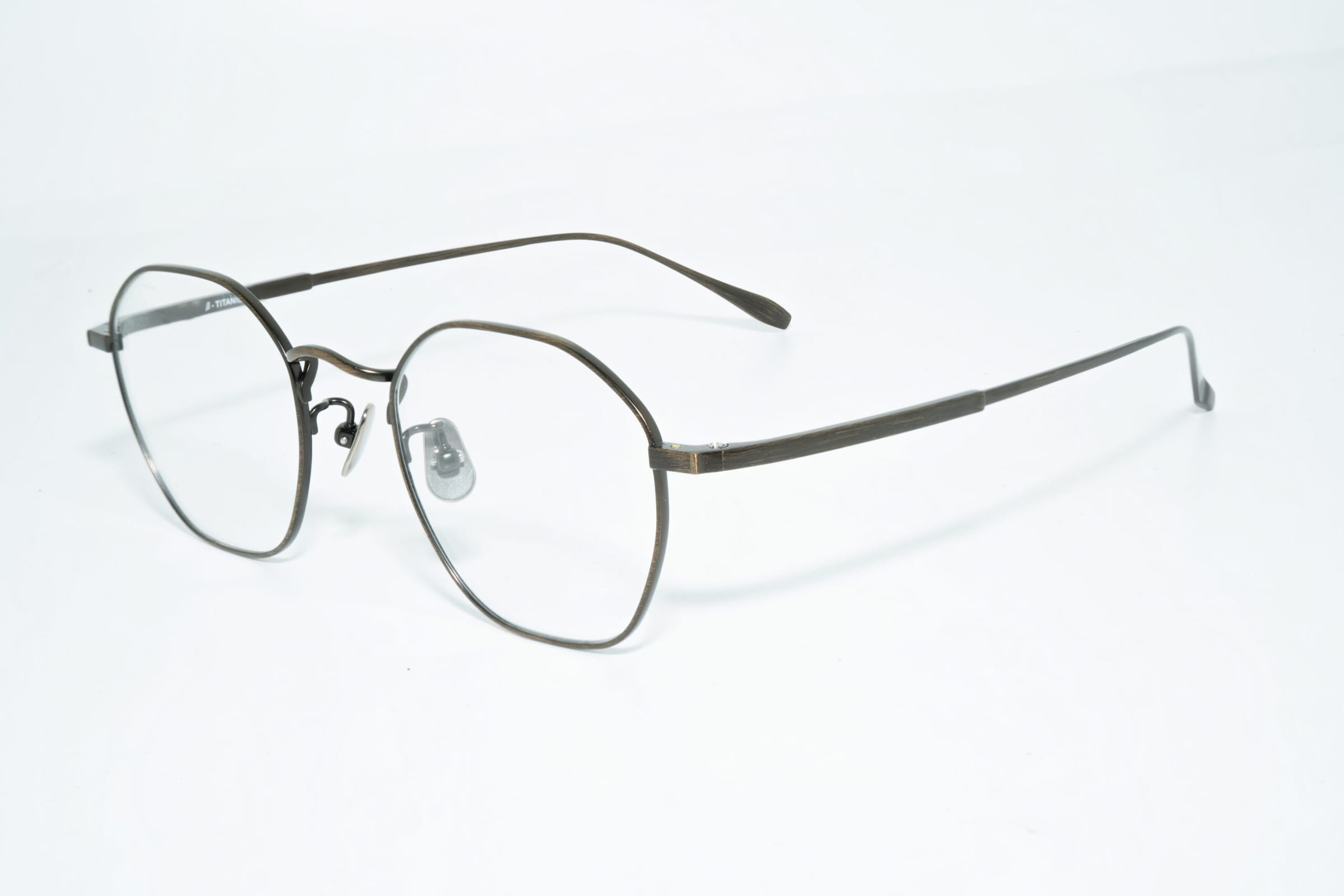 Eyeglass frame with softly angular gray rims, clear nose pads and slim temples.