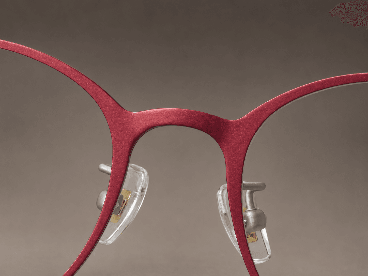S-L7026 crimson red front bridge and softly squared rims with clear nose pads.