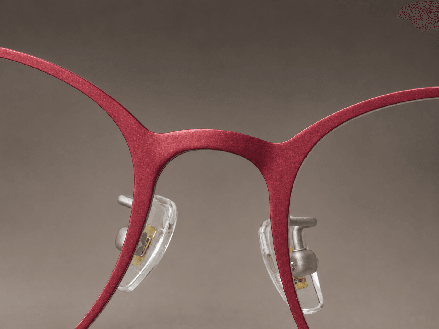 S-L7026 crimson red front bridge and softly squared rims with clear nose pads.