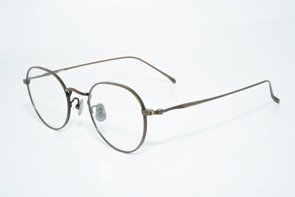 Eyeglass frame with round bronze-colored rims, clear nose pads and slim temples.