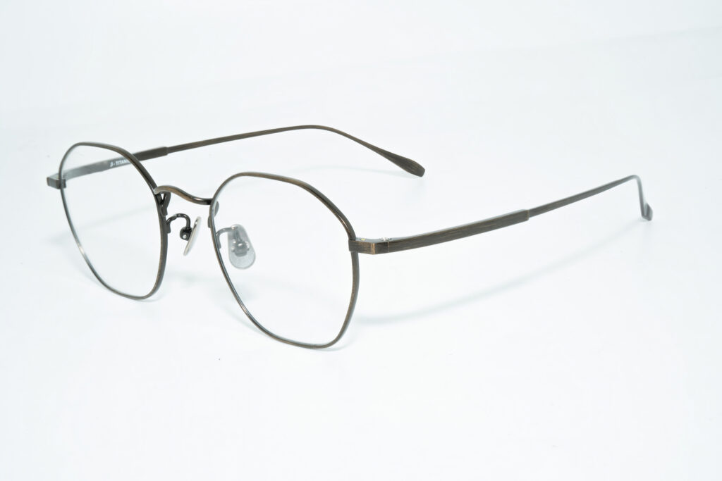 Eyeglass frame with softly angular gray rims, clear nose pads and slim temples.